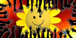 A vibrant illustration depicting a smiling sun surrounded by numerous silhouetted hands reaching upwards against a red and orange mosaic backdrop, symbolizing positivity, unity, and the wisdom of the crowd.